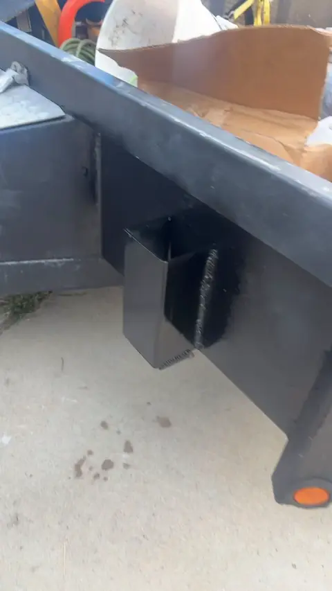 Black utility trailer with the attached custom metal pockets, view one